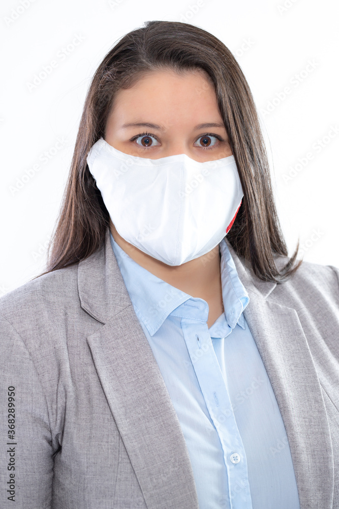 Young professional lady poses for a studio headshot. She is caucasian with long hair. She is wearing a mask for health protection. Young professional lady poses for a studio headshot. She is caucasian with long hair. She is wearing a mask for health protection.