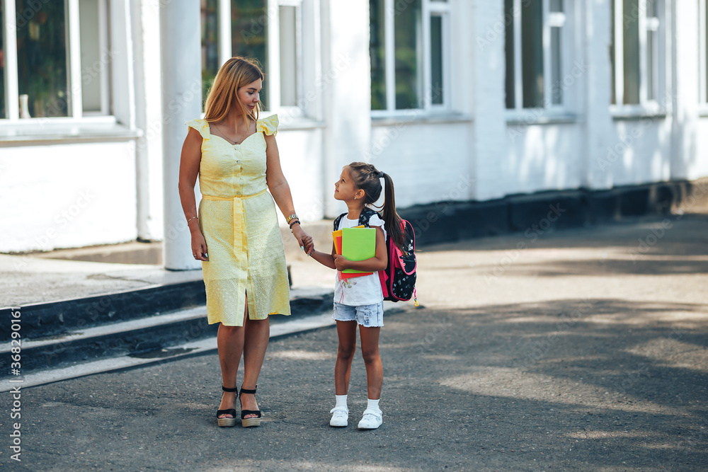 Mom holding her child s hand, mom meets her child from school, back to school