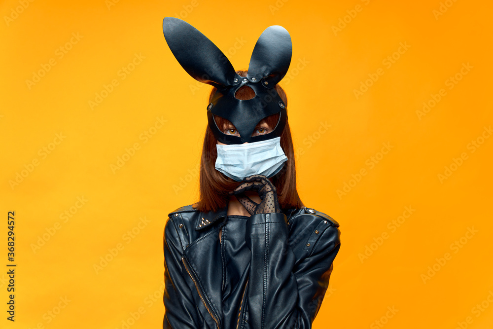 Female rabbit mask posing sexually in a medical mask from coronavirus Female rabbit mask posing sexually in a medical mask from coronavirus