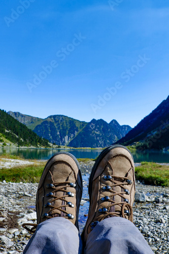 Two brown female boots near Gaube Lake, Lac de Gaube, in the Pyrenees mountains, mountain range between Spain and France