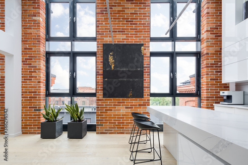 Kitchen with big windows and brick walls photo