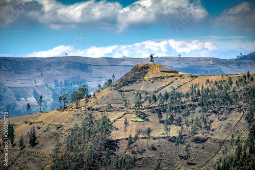 View of the mountains surrounding the city of Guaranda, with the Santa Fe (Holly Faith) touristic monument at the top of the hill. Ecuador, South America.
