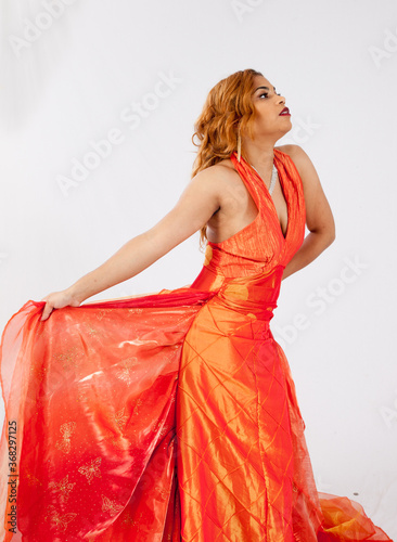 Lovely Hispanic woman playing with her dress