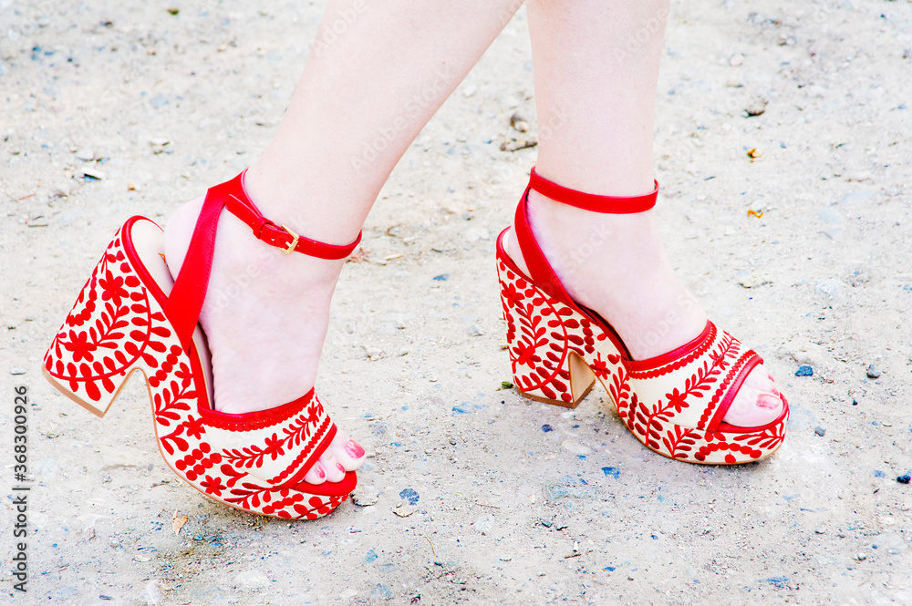 Woman likes to walk in her red high heeled funky fashion shoes. Woman likes to walk in her red high heeled funky fashion shoes.