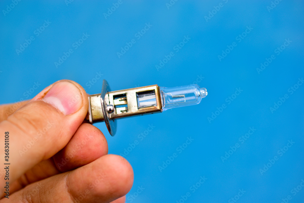 Car low-beam and high-beam light bulbs in your hands Car low-beam and high-beam light bulbs in your hands