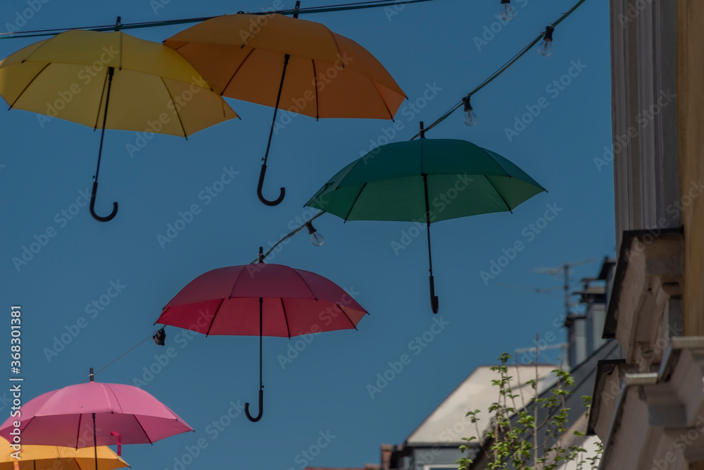 Color umbrellas with blue background sky over street in VIllach city