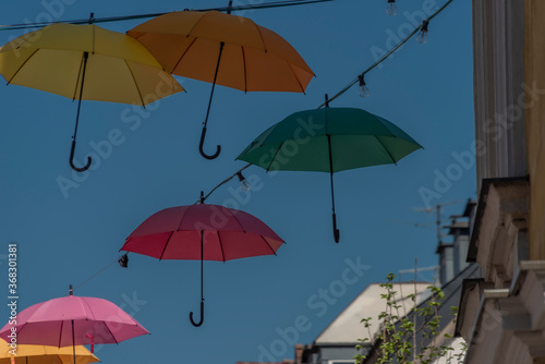 Color umbrellas with blue background sky over street in VIllach city