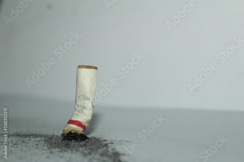 This is a photo of a cigarette butt on a white background