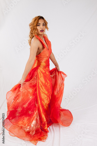 Lovely Hispanic woman playing with her dress