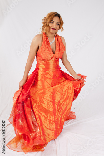 Lovely Hispanic woman playing with her dress