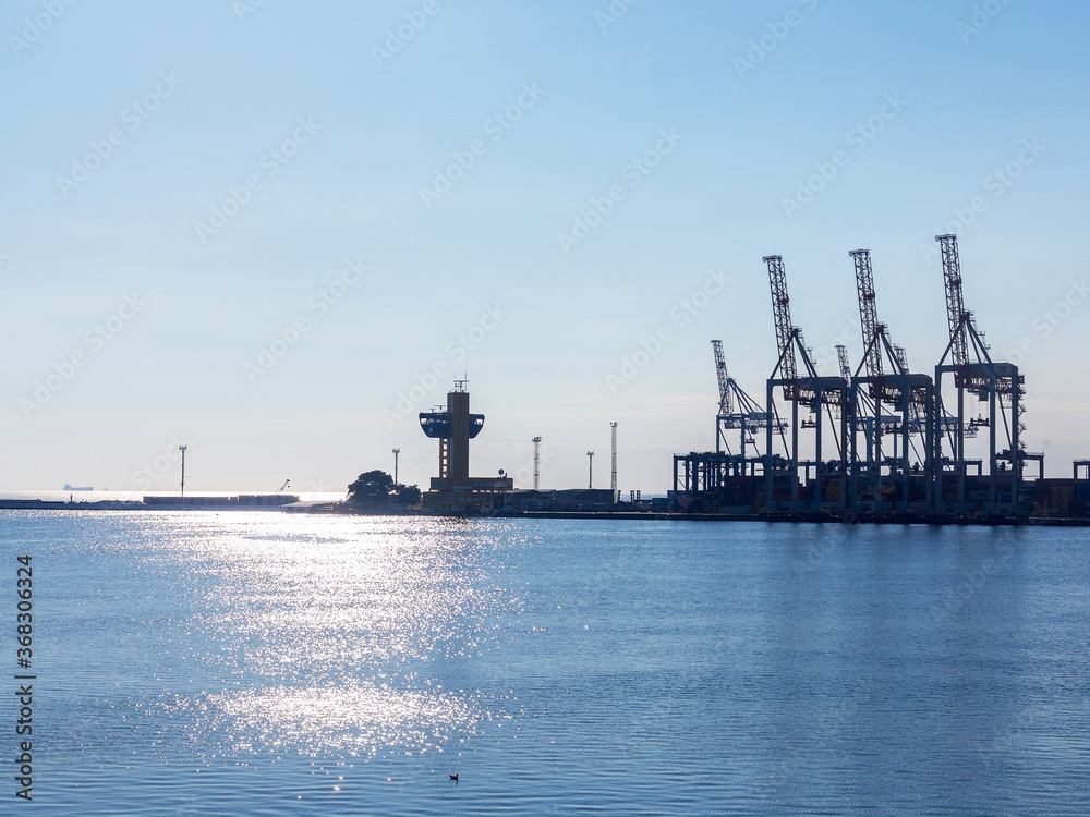 Odessa, Ukraine - August 15, 2016: Container cranes in cargo port terminal, cargo cranes without job in an empty harbor port. 