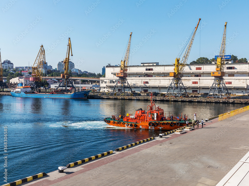 Odessa, Ukraine - August 15, 2016: Container cranes in cargo port terminal, cargo cranes without job in an empty harbor port. A crisis. Odessa, Ukraine, August 15, 2016
