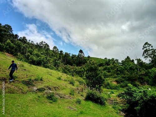 Beautiful landscape of the Munnar city in Kerala, India with valley and mountains view. Grasslands of beautiful hill station of India, Munnar with selective focus for leisure and tourism purposes.