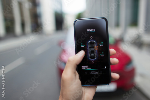 POV Man using remote car access app on smart phone photo