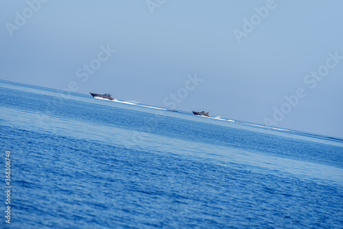 2 motor yachts cruising the ocean