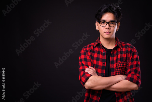 Young handsome Asian hipster man with eyeglasses