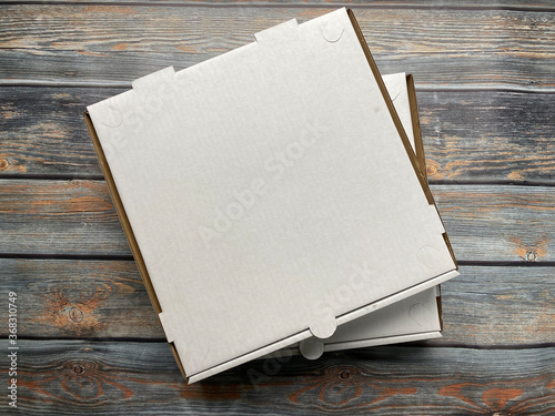 Pizza box on wooden table photo