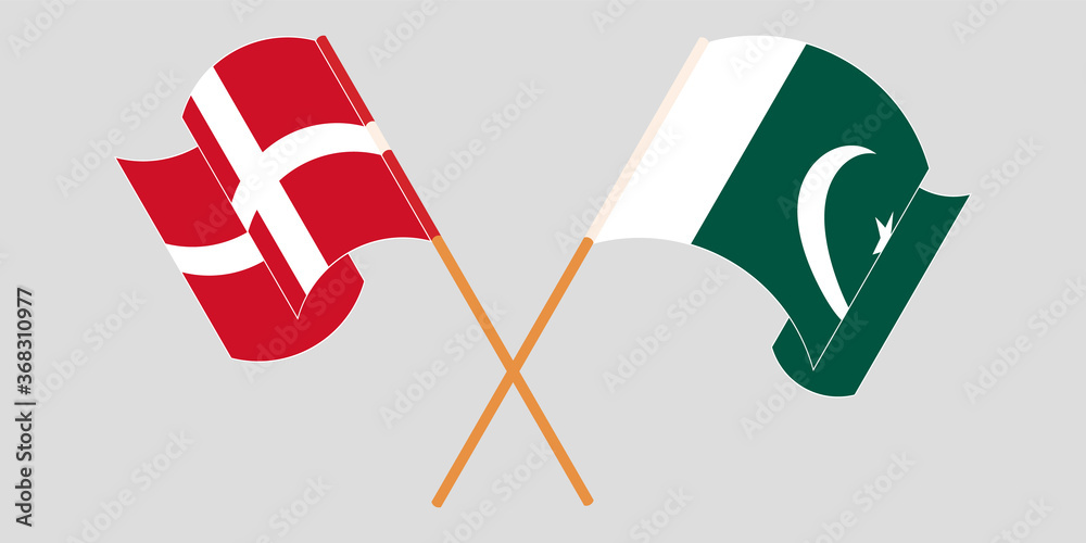 Crossed and waving flags of Pakistan and Denmark