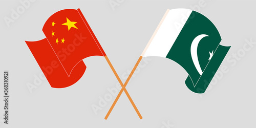 Crossed and waving flags of Pakistan and China