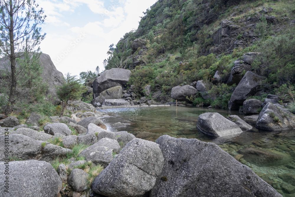 Green lagoon surrounded by rocks in Geres National Park Green lagoon surrounded by rocks in Geres National Park