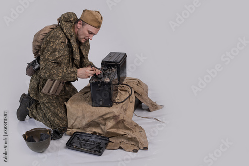 Male actor in the historical uniform of an officer of the Soviet Army with an intercom radio during World War II photo