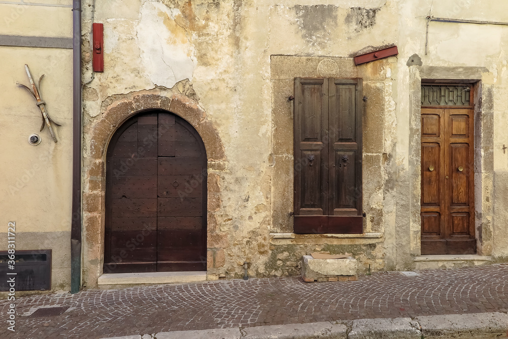 Fototapeta premium Wooden doors on the facade to the ancient medieval city of Leonessa, Lazio region, Rieti province, Italy