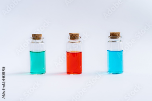 Three closed vials with colored contents.