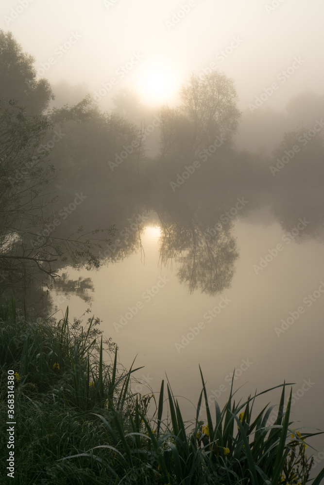 Morning fog over the river at sunrise. Blurred background.