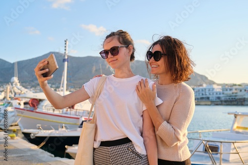 Happy family on vacation, mom and teenage daughter taking selfie on smartphone © Valerii Honcharuk