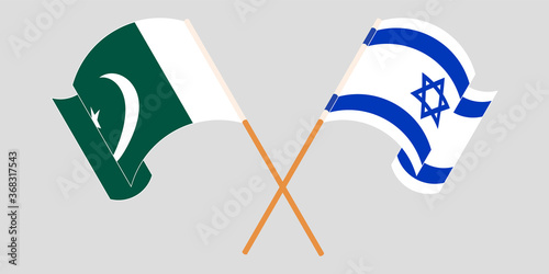 Crossed and waving flags of Pakistan and Israel