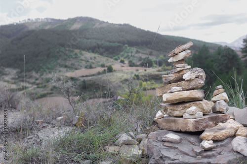 Cairn. Stone pyramid. Make a wish. A symbol of harmony and peace. Route pointers. Commemorative handful of stones. Believe in miracle. Keep calm. Way of St. Jacob. Camino de Santiago. © Larysa