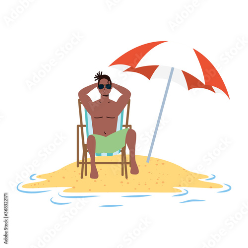 afro man relaxing on the beach seated in chair and umbrella