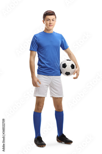 Full length portrait of a teenager soccer player with a ball under arm © Ljupco Smokovski