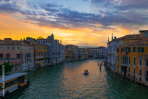 A wonderful evening shot of the Canal Grande and its palaces seen from the Accademia Bridge or Ponte dell'Accademia. Sunset with orange and blue clouds reflecting on the water. Venice, Italy. © Paolo Savegnago