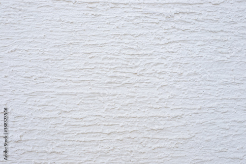 white textured plaster. Decorative wall covering with horizontal stripes. Construction and real estate.