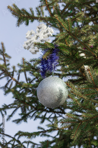 Christmas decorations on branches of Christmas tree.