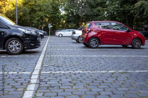 parking cars in a parking lot with paving stones