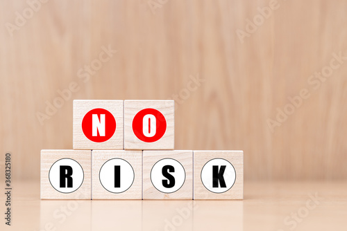 Wooden cubes with message No Risk on wooden background