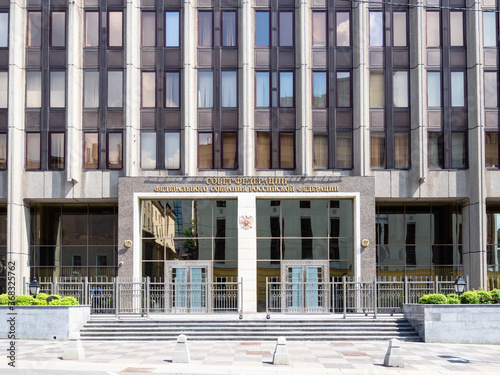 front view of entrance to building of Federation Council of the Federal Assembly of the Russian Federation on Bolshaya Dmitrovka Street in Moscow city in summer.