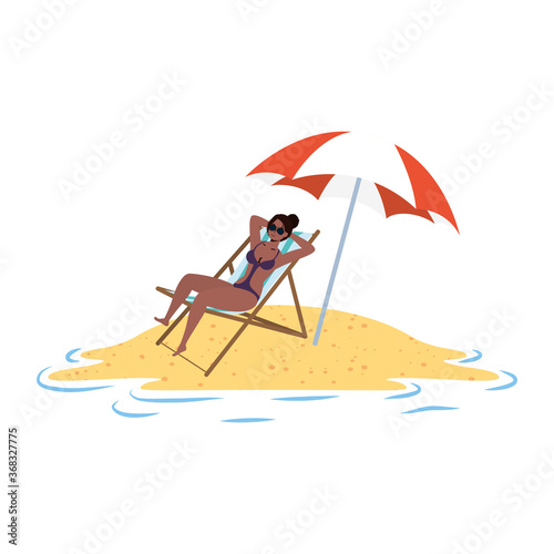 young afro woman relaxing on the beach seated in chair and umbrella