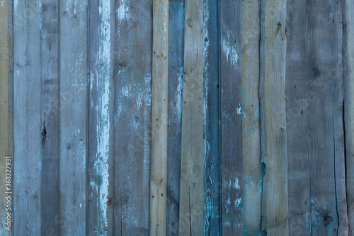 Wooden old vintage fence painted with turquoise paint. Abstract background made of texture boards.