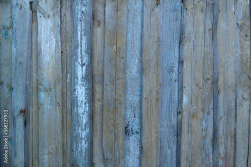 Wooden old vintage fence painted with turquoise paint. Abstract background made of texture boards.