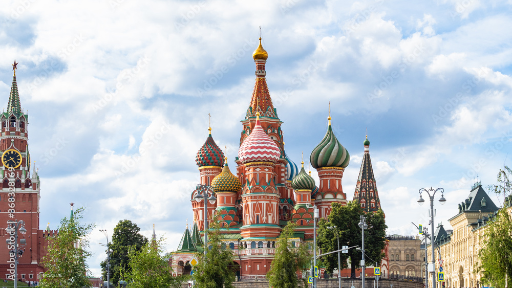 panoramic view of Vasily the Blessed (Saint Basil, Pokrovsky) Cathedral and Kremlin tower on Red Square during city sightseeing tour on excursion bus in Moscow city on sunny summer day