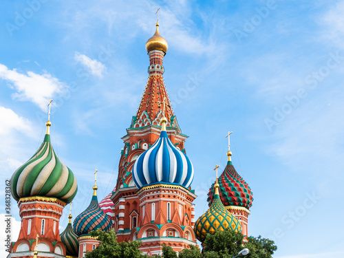 view of cupola of Saint Basil (Vasily The Blessed, Pokrovsky) cathedral under blue sky during city sightseeing tour on excursion bus in Moscow city in summer