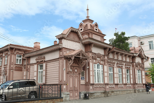 Bild auf Leinwand Vintage wooden Polutov's house with carved windows on Lenin Street, 100 in Chita city, Russia