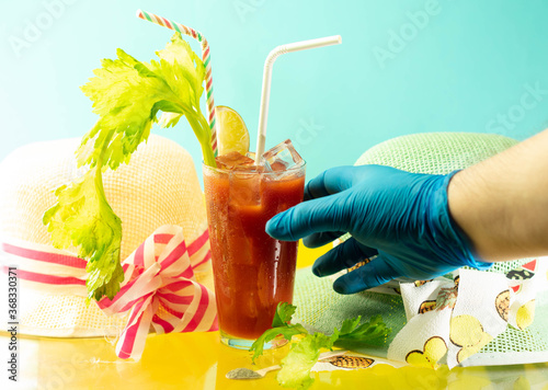 gloved hand by covid 19 reaching bloody mary