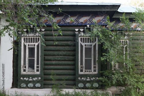 Vintage wooden Timokhovich's house with ornamental carved windows, frames and fishes on Nagornaya Street, 38 in Chita city, Russia. Russian folk style in architecture. Chita landmark, monument, sight photo