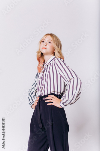 Back to school. Cute adorable caucasian blondie girl with glode in school uniform on white background photo