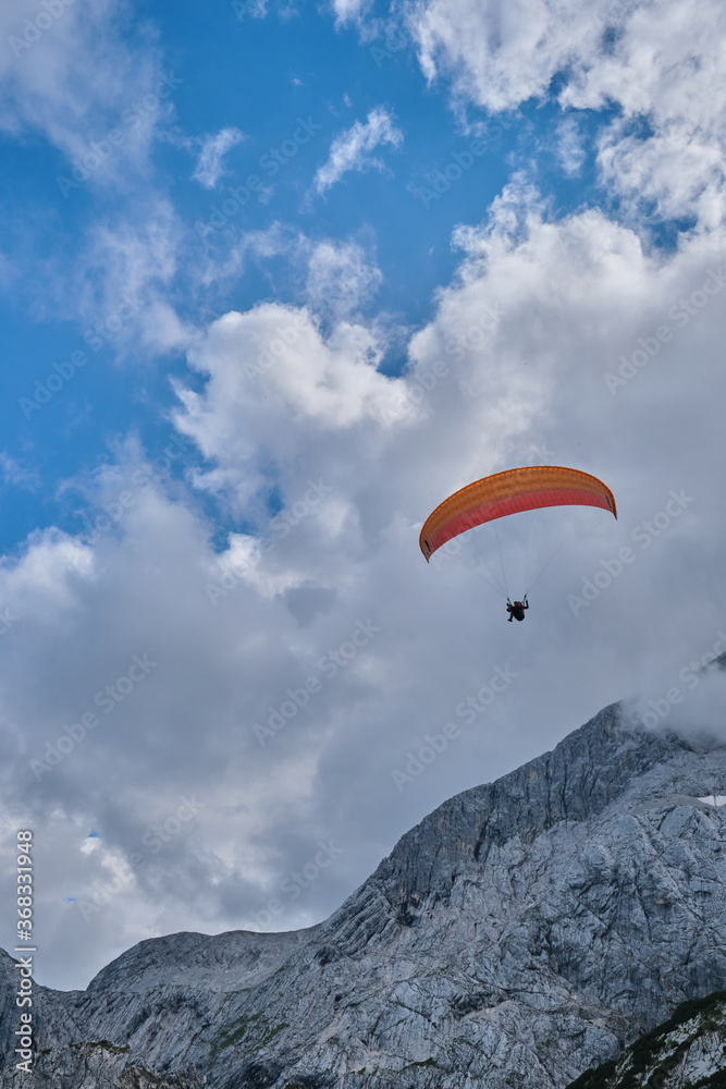 Paraglider near the peak of the mountain Paraglider near the peak of the mountain