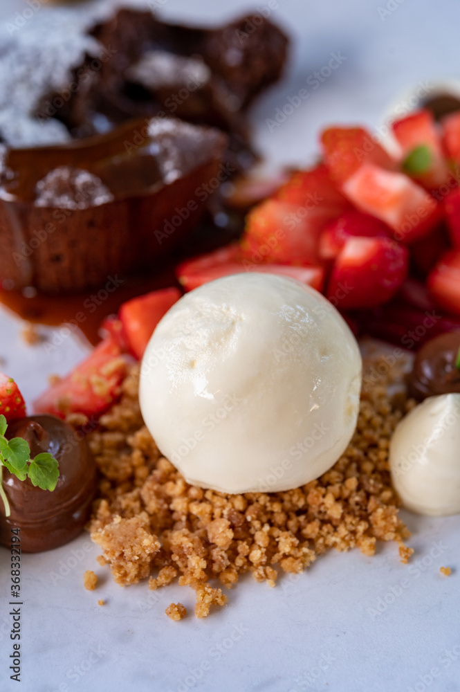 Tasty dessert, hot chocolate cake and vanilla ice cream with fresh strawberry Tasty dessert, hot chocolate cake and vanilla ice cream with fresh strawberry